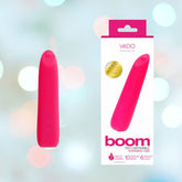 A vibrant pink rechargeable warming vibrator with an elegant design, the VeDO Boom Rechargeable Warming Bullet Vibrator - Pink, stands upright next to its packaging box. The box features an image of the product, along with the brand name "VeDO" and the product name "Boom." The background is softly blurred with light circles.